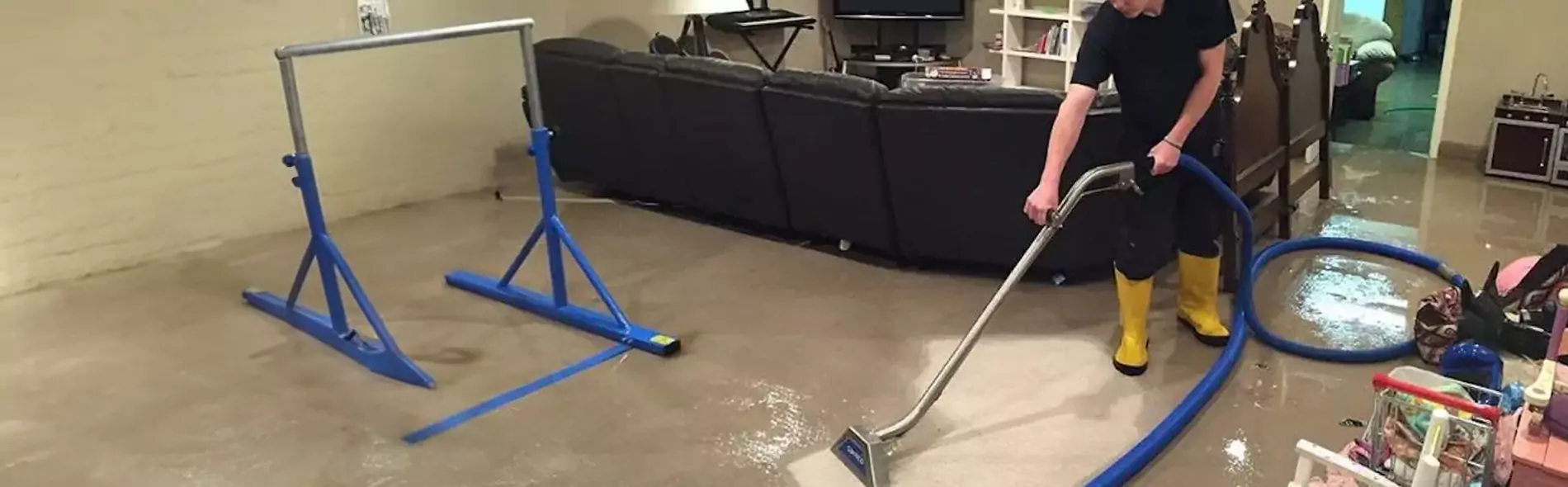 Person cleaning floor with industrial vacuum