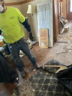 A CleanUP Guys crew member in branded gear working a water damage restoration job in Chicago