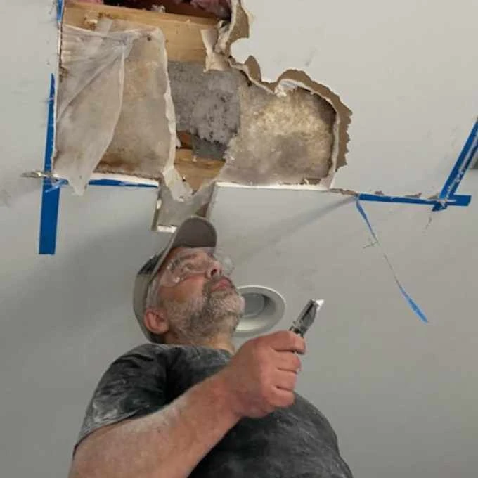 The CleanUP Guys technician repairing commercial ceiling damage in Chicago
