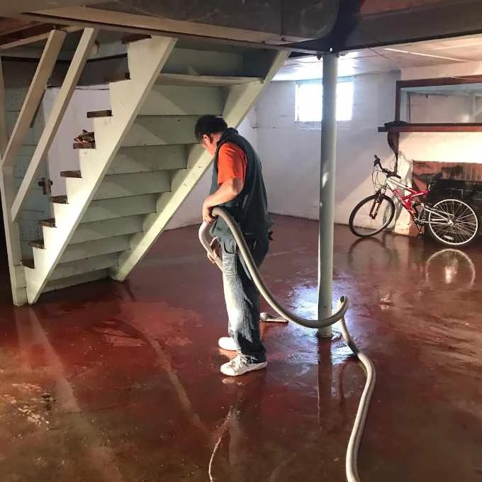 The CleanUP Guys technician cleaning and drying a Chicago basement floor