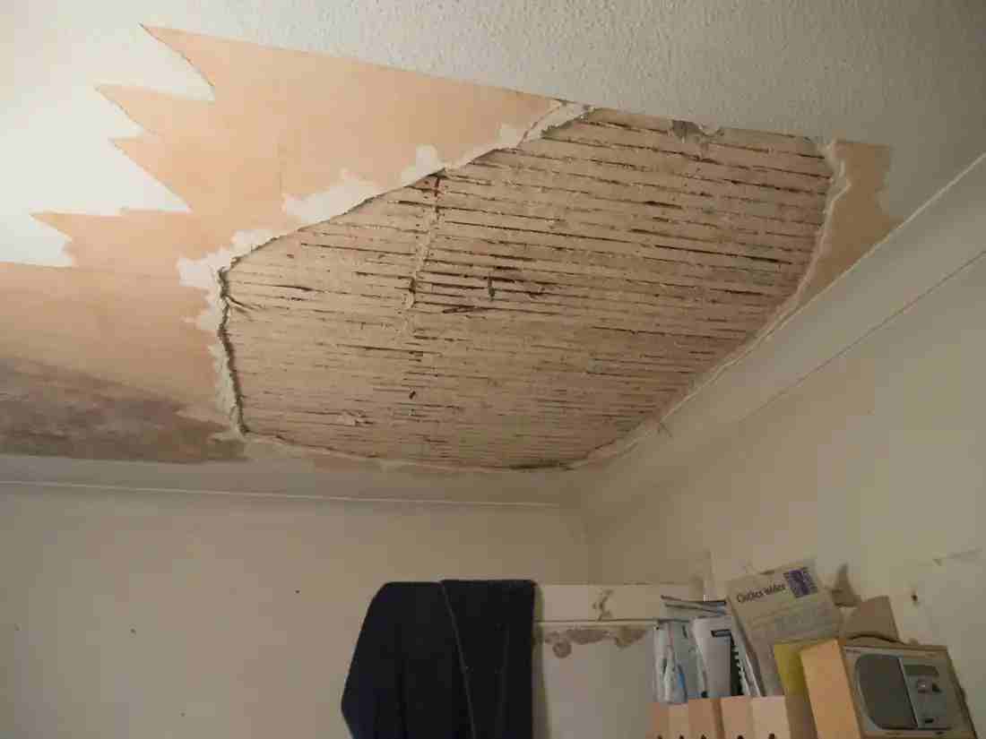 Damaged plaster ceiling exposing wood lath in a Chicago home
