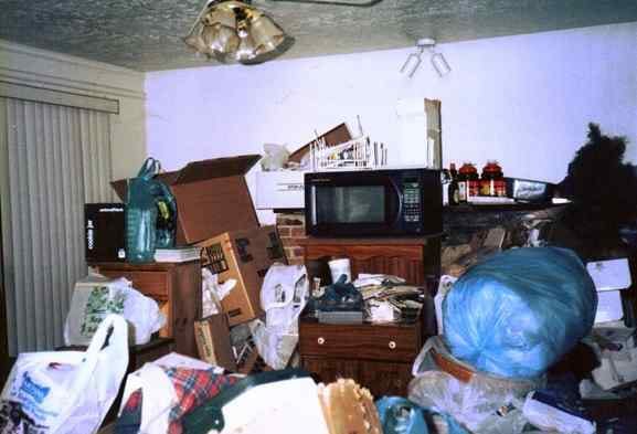 Cluttered room filled with boxes, bags, and household items before a cleanout in Chicago
